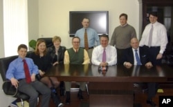 Konstantin Kilimnik (left) poses with Paul Manafort (center in white shirt) and others in 2006.