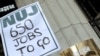 A protester holds up a placard during a rally in front of BBC's Bush House in London on January 26.