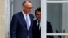 French President Emmanuel Macron walks with Germany's newly elected chancellor, Friedrich Merz, at the Elysee presidential palace in Paris on May 7.
