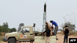 Forces loyal to Libya's UN-backed unity government prepare a missile launcher during clashes with Islamic State (IS) militants west of Sirte earlier this month. Libyan forces began the battle to retake the city from IS in May.