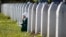 A woman mourns among graves at a Memorial Center near Srebenica for some 8,000 people who were killed in a massacre there during the Bosnian War. Srebrenica had been declared a safe zone by the United Nations at the time. 