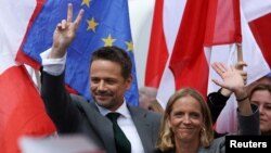 Polish presidential candidate Rafal Trzaskowski (left) holds an election rally in the city of Plock on May 11.