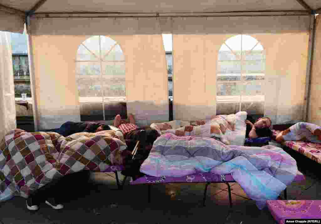 A group of around 30 protesters spent the night in tents outside the old parliament building, monitored by police, who have also erected barricades on the building's steps.