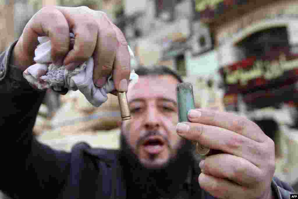 An Egyptian man displays empty bullet cartridges in Cairo’s Tahrir Square on January 29, 2011.