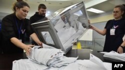 Members of a local electoral commission count ballots during at a polling station in Novosibirsk, Russia, on March 17.