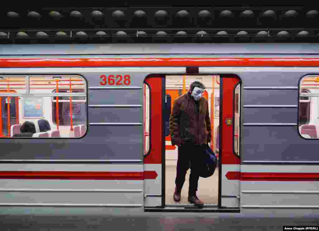 A man exits a subway car wearing a Guy Fawkes mask on March 17. The day before, Prague's mayor said on Twitter: “On Prague public transport, it is mandatory to have a covered mouth and nose! Whether you have medical masks, self-made masks, or use a scarf, anything is better than nothing.” 