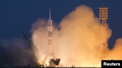 The Soyuz TMA-07M spacecraft carrying a three-man crew blasts off from the Baikonur Cosmodrome.