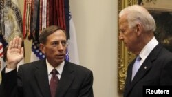 U.S. Vice President Joe Biden (right) swears-in David Petraeus as the new CIA chief at the White House in Washington, DC.