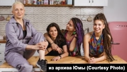 Yuma (left) with her daughters: Mila (far right) and Alina (second from the right). Alina's girlfriend and fiancée, Ksyusha, is second from the left.