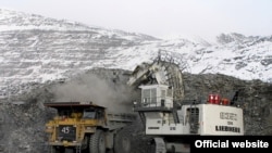 Trucks load ore at the Kumtor gold mine