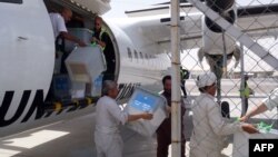 Afghan election commission workers, overseen by NATO-led Italian troops, unload ballot boxes flown in on a UN aircraft from Farah Province and to be sent onward to Kabul, at Herat airport on July 24.