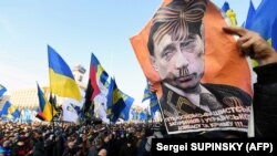 Плакат із зображенням президента Росії Володимира Путіна під час акції «Червоні лінії для Зе». Київ, 8 грудня 2019 року
