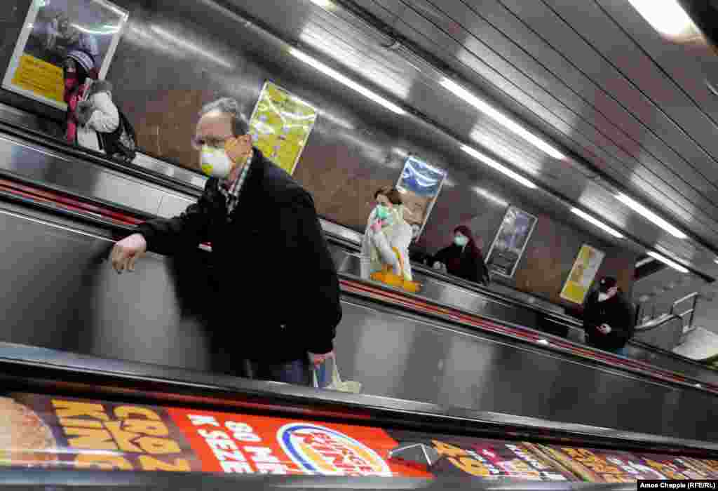 Commuters wearing masks ascend an escalator on March 17. 