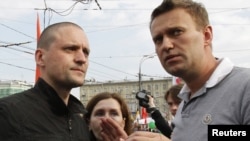 Opposition leaders Sergei Udaltsov (left) and Aleksei Navalny speak together during an opposition protest in central Moscow earlier this month.
