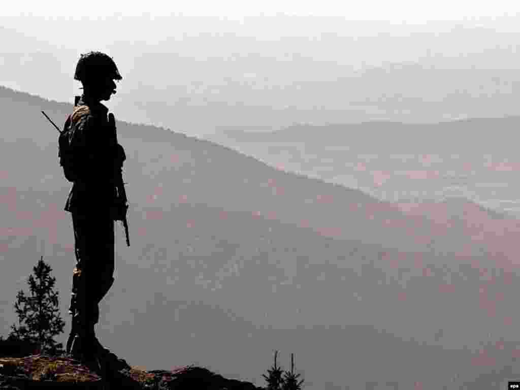 A Pakistani Army soldier looks out over the rugged Afghan-Pakistani border from the Pakistani tribal belt - Pakistani Foreign Minister Khurshid Kasuri said in May 2007 that Islamabad is likely to remain a U.S. ally based on the need for cooperation over neighboring Afghanistan. He added that he thinks Washington understands Pakistan's "fundamental" role in Afghanistan's future.