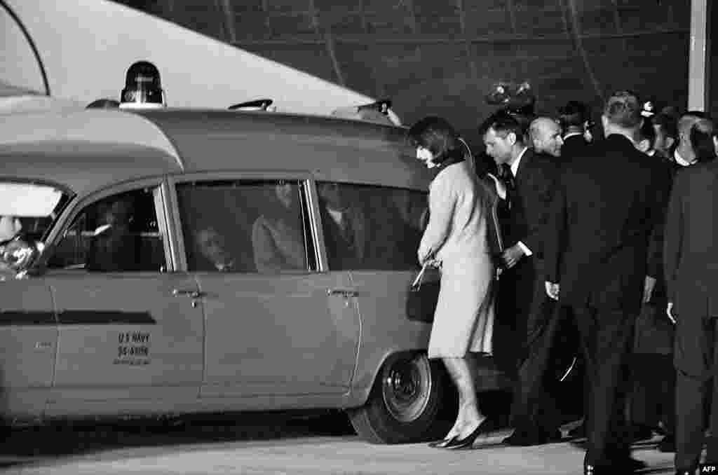 The slain president's body arrives at Andrews Air Force Base outside Washington and is attended to by his wife, Jacqueline Kennedy, and his brother, U.S. Attorney General Robert Kennedy.