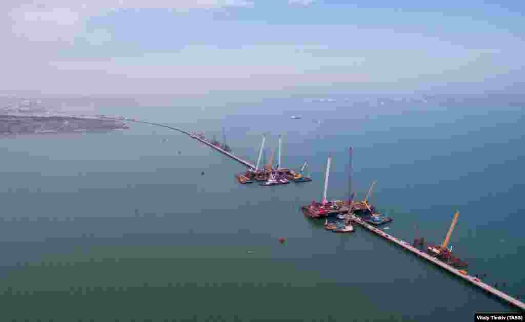 The arches straddle this gap in the bridge, designed to allow ships to pass beneath. Critics of the project say the planned 35-meter clearance under the bridge will be dangerously tight during stormy weather. Previous, stalled plans for a bridge across the strait called for clearance of at least 50 meters. 