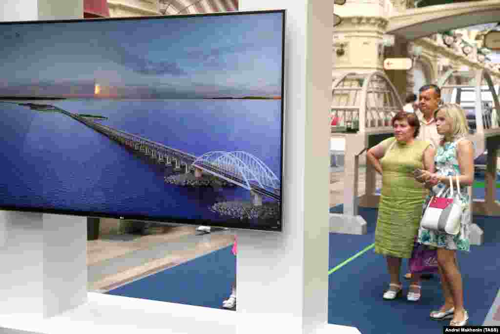 In a shopping mall in central Moscow, an exhibition tells the story of the Kerch bridge's construction. Russia's 2014 annexation of Crimea won the country international condemnation but caused a wave of patriotic fervor inside Russia that carried President Vladimir Putin to approval ratings of 83 percent.