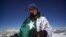 Mountaineer Samina Baig poses with a Pakistani flag during a previous climb.