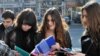 Representatives of Transparency International distribute copies of the corruption report to students in Tbilisi as part of Anticorruption Day activities.