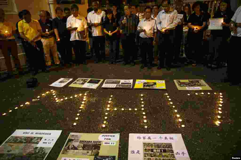People hold candles during a candlelight vigil for victims of the downed Malaysia Airlines Flight MH17, in Kuala Lumpur on July 19. 