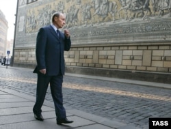 Vladimir Putin walks along a street in Dresden, where he was stationed from 1985 to 1990.