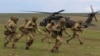 British soldiers disembark from a U.S. military helicopter during the "Wind Spring 15" military exercises at Smardan shooting range April 21, 2015.