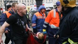 An injured person is helped by emergency services outside Sennaya Ploshchad subway station.