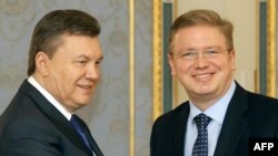 Ukrainian President Viktor Yanukovych (left) and European Enlargement Commissioner Stefan Fuele in Kyiv on February 8.