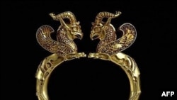 U.K. -- A gold griffin-headed armlet from the Oxus treasure Achaemenid Piersian, 5th-4th century BC, presented by the British Museum, 07Sep2005