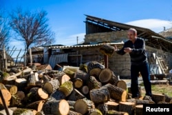 An ethnic Tartar piles wood in his garden in Belogorsk, near the Crimean capital, Simferopol.
