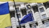 Ukraine -- Ukrainian national flags, flags of Ukrainian trade unions and EU flag are seen during a mass rally in front of the Ukrainian cabinet of ministers building in Kyiv, October 15, 2014