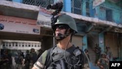 Pakistani soldiers patrol at an empty bazaar during a military operation against Taliban militants in Miranshah in North Waziristan in 2014.