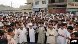 People pray for victims of the August 21 suicide attacks near Islamabad