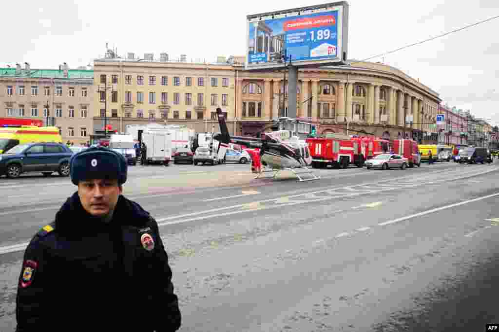 Emergency vehicles and a helicopter seen outside the entrance to St. Petersburg's Tekhnologichesky Institut subway station. 