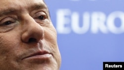 Italian Prime Minister Silvio Berlusconi talks to the media as he leaves a eurozone leaders summit in Brussels in October.