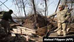 Ukrainian soldiers dig and equip trenches at their new positions not far from the town of Zolote in the Luhansk region on November 2.