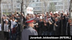 Supporters of the detained opposition lawmakers protest in front of the court in Bishkek on March 29.