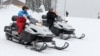 Russian President Vladimir Putin (left) and his Belarusian counterpart Alyaksandr Lukashenka ride snowmobiles following their talks in Sochi on February 22.