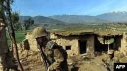 Pakistani soldiers patrol the compound of Taliban leaders in Bajaur, one of the country's tribal regions.