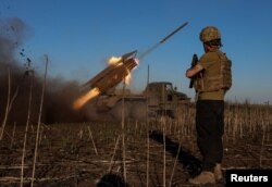 Ukrainian servicemen fire a Grad MLRS toward Russian troops near the frontline town of Pokrovsk on April 19.