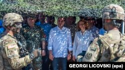 Macedonian Prime Minister Zoran Zaev (C) and Defense Minister Radmila Secerinska (R) meet with U.S. troops during a joint military exercise