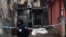 A police officer walks by the crime scene in Cetinje, Montenegro, on January 2, 2025, after a gunman went on a rampage after opening fire at a village restaurant, killing 12 people including two children.