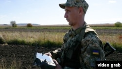 A Ukrainian guard uses a drone to search the border for illegal crossings