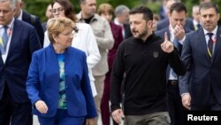 Ukrainian President Volodymyr Zelenskiy speaks with Swiss Federal President Viola Amherd after a press statement at the Summit on Peace in Ukraine, near Lucerne, Switzerland, on June 15.