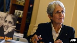 U.S. folk singer Joan Baez signs her autobiography during a visit to Prague on September 16.