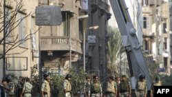 Military personnel erect a concrete barrier to separate police and protesters just off Cairo's Tahrir square on November 24.