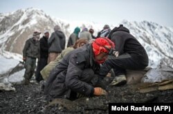 A man searches for emeralds in the Mikeni Valley.