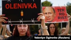 Relatives of defenders of the Azovstal steelworks in Mariupol hold a rally in Kyiv on July 30 demanding that Russia be designated as a terrorist state following the deaths of Ukrainian POWs in a deadly attack on a prison in Olenivka.