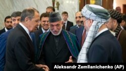 Former Afghan President Hamid Karzai (center) introduces the Taliban delegation to Russian Foreign Minister Sergey Lavrov (left) ahead of their meeting in Moscow on May 28.